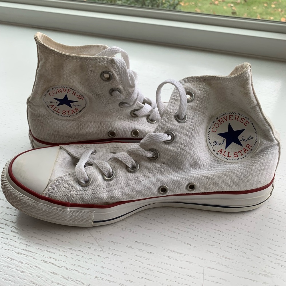 High top white converse sneakers.